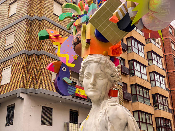 Valencia, Spain - March 13, 2025: Low angle close-up view of a Ninot resembling a classic sculpture in front of residential building. These are huge dolls that are built specifically to be burnt during the last night of Las Fallas annual event, exclusive to the Valencian Community