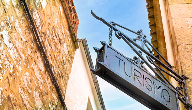 istock An iron sign hanging from a building that says Turismo 2206177807