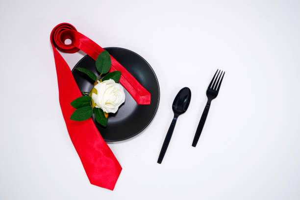 istock Red tie folded  on ceramic plate with white background close-up view 2206179163