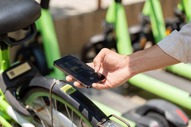 istock Sustainable Transportation and Technology. A person using a smartphone to access a bike-sharing app for eco-friendly travel. 2206179953