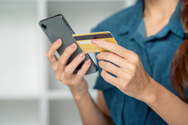 istock Finances and Smart Spending. A woman managing her funds by using her credit card while checking her smartphone. 2206181153