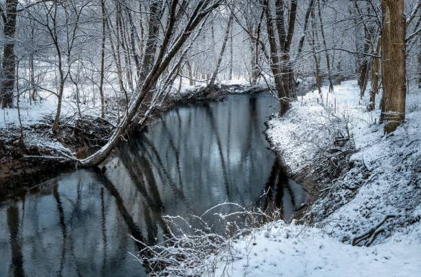 istock Serene winter landscape with snowy forest and stream. 2206182013