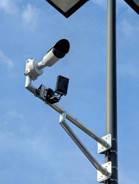 istock Parking lot surveillance camera mounted on metal poleParking lot surveillance camera mounted on metal pole 2206183030