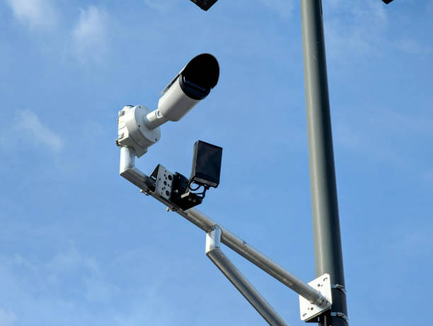 istock Parking lot surveillance camera mounted on metal poleParking lot surveillance camera mounted on metal pole 2206183040