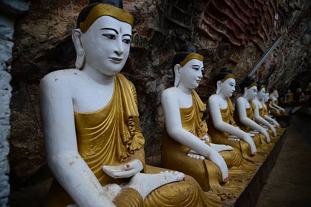 Serene Buddha statues in a cave, reflecting spiritual tranquility and cultural significance in Myanmar