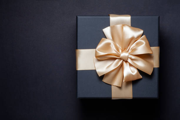 istock black gift box with champagne gold ribbon bow 2206183754