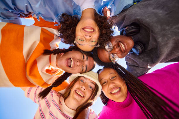 istock Five Gen Z friends embracing in a circle, looking down at the camera 2206183822