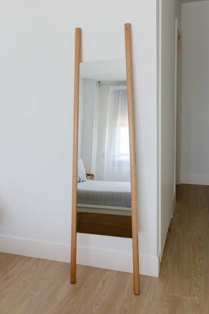 istock Bright minimalist bedroom with large wall mirror and reflection of the bed 2206184049