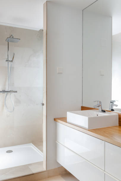 istock Luxury chrome shower, sink and mirror in modern marble bathroom with natural light for relaxing moments 2206184066