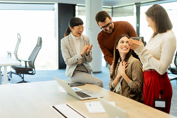 istock Team celebrates success together in a bright modern office environment 2206186013