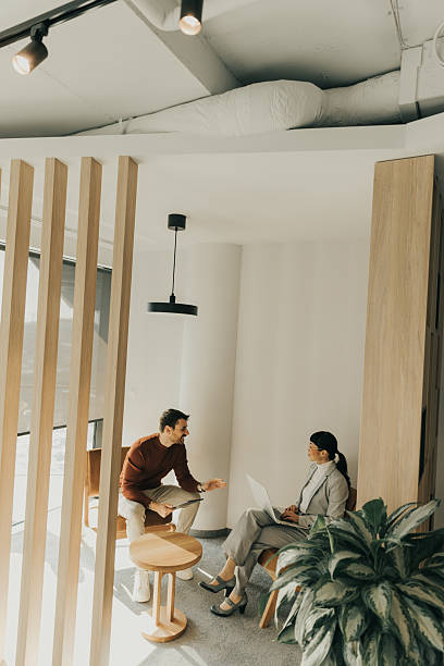 istock Engaging discussion between colleagues in a bright modern workspace during afternoon hours 2206186028
