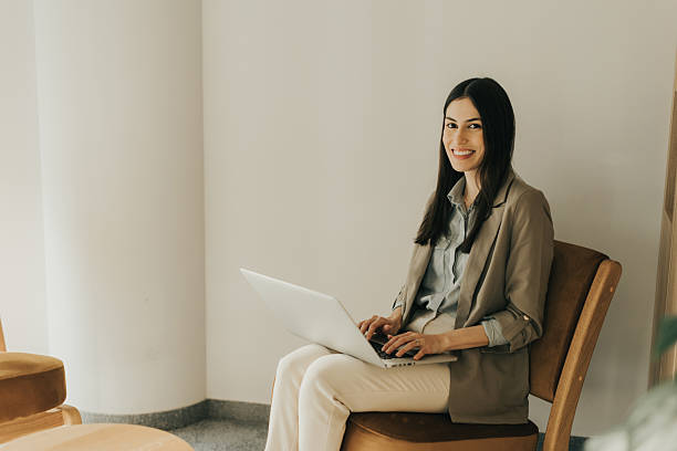 istock Professional woman working on a laptop in a cozy modern workspace during the day 2206186035