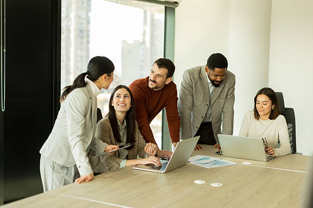 istock Collaboration thrives in a modern office with stylish professionals engaged in discussion 2206186061