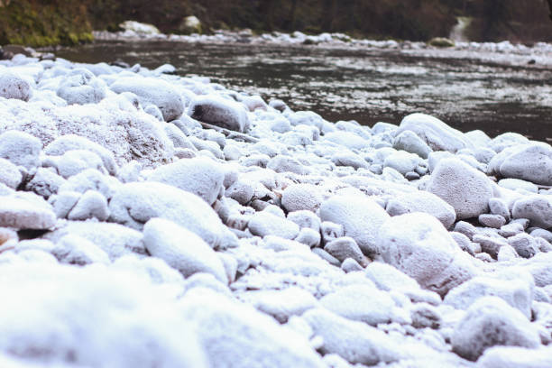 Frozen river in winter with snow and ice on the rocks, Georgia