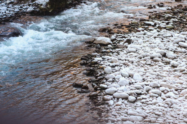 Frozen river in winter with snow and ice on the rocks, Georgia