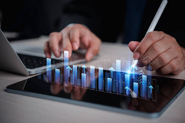 istock business man analyzing digital financial charts and growth trends on a tablet, highlighting the role of technology and data analysis in modern market research and business planning strategies. 2206186986