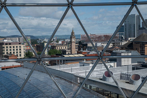 Belfast, Northern Ireland -  August 4, 2023:  Panoramic view from Victoria Square in Belfast showcases the city diverse architecture under a partly cloudy sky, with the iconic Albert Memorial Clock tower standing prominently among the buildings
