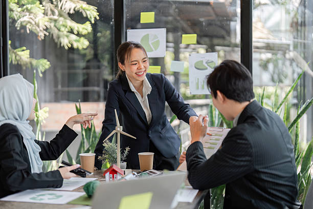 istock Sustainability and Team Collaboration. A professional team engages in a discussion about sustainable practices in an eco-friendly workspace. 2206190190