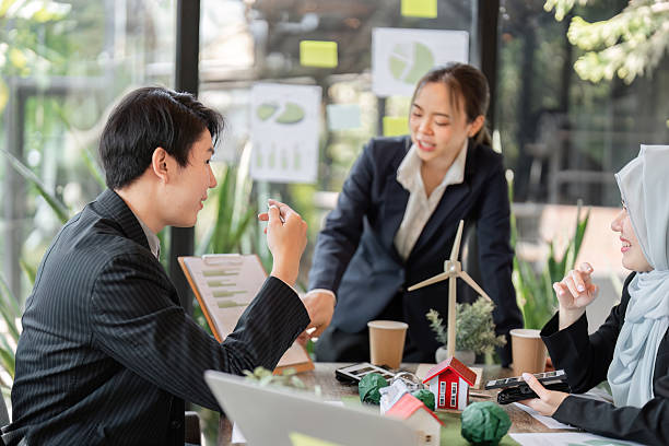 istock Innovative Solutions and Eco-Consciousness. Team brainstorming on environmental sustainability in their workspace. 2206190206