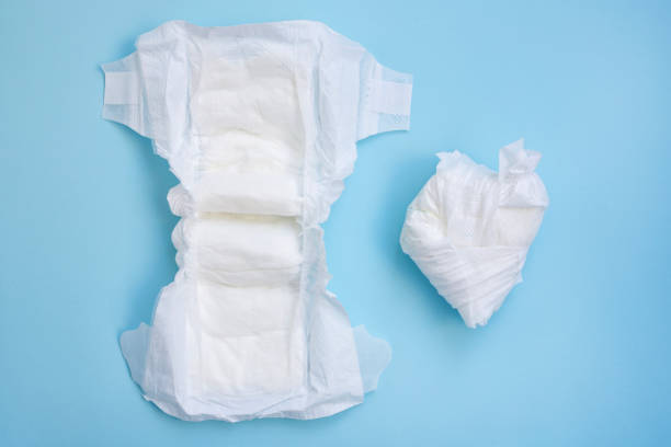 istock New and used baby diapers on a blue background. 2206190216