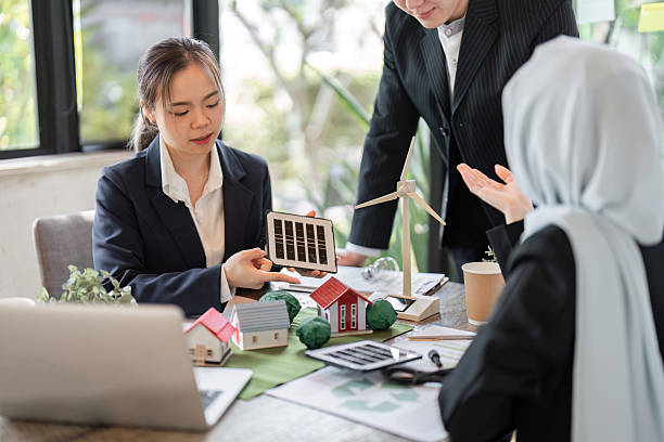 istock Collaboration and Green Solutions. Professionals showcasing renewable energy models in a design meeting. 2206190563