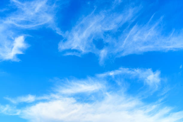 istock Wispy White Clouds Scattered Across the Azure Sky 2206192423
