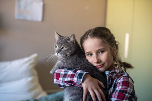 Little Girl spending her time with her cat at home