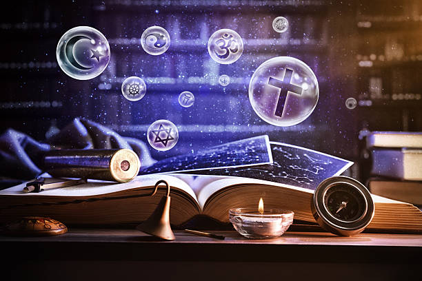 Book and objects in library with bubbles with religious symbols stock photo
