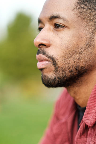istock Pensive black man contemplating outdoors in nature 2206199074