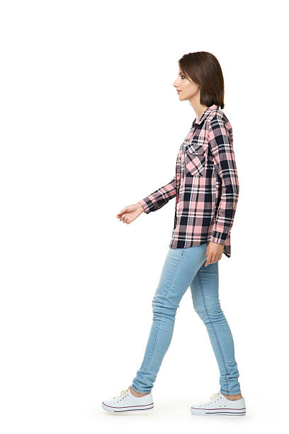 istock Beautiful young woman walking on white background 2206204138