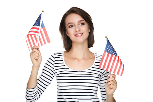 istock Beautiful young woman holding american flags on white background 2206204855