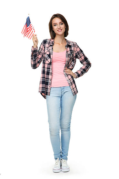 istock Beautiful young woman holding american flags on white background 2206205452