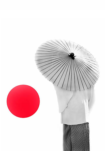 Vibrant red umbrella glistening with raindrops under bright sunlight creates striking contrast between wet and dry, highlighting texture and evoking a sense of protection