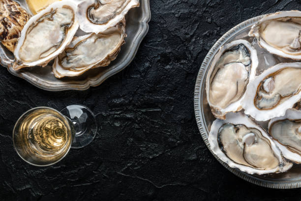 istock Fresh raw oysters on ice, overhead flat lay shot 2206207316