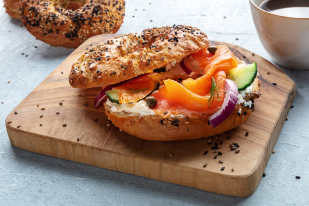 istock Lox bagel. A sandwich with smoked salmon and fresh vegetables 2206207351