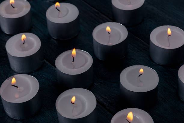 istock Tea light candles on a dark background, many lights in the dark 2206207357