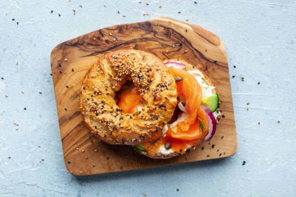istock Lox bagel. A sandwich with smoked salmon and fresh vegetables 2206207365