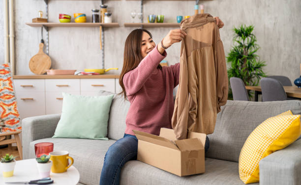 istock Woman unboxing clothes after online shopping 2206210000