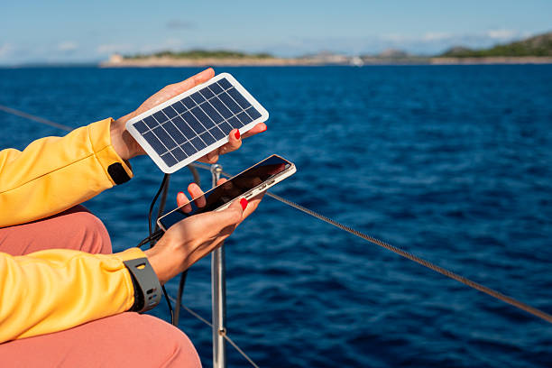 istock Charging smartphone with portable solar panel 2206212826