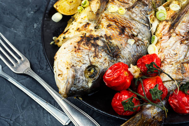 istock Deliciously baked dorado served with vibrant vegetables. 2206214928