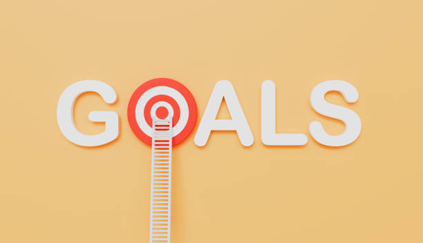 istock Ladders leaning on goals written eye target on wall pastel color background 2206215468