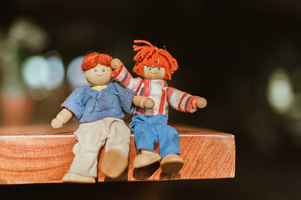 handmade wooden doll on blur background.