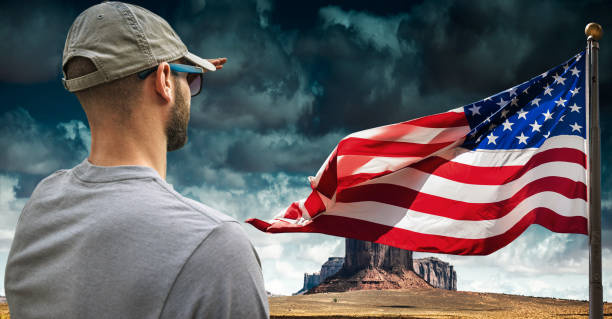 istock man looking forward with us flag in the background 2206218090