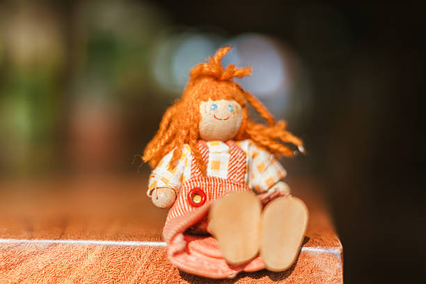 handmade wooden doll on blur background.