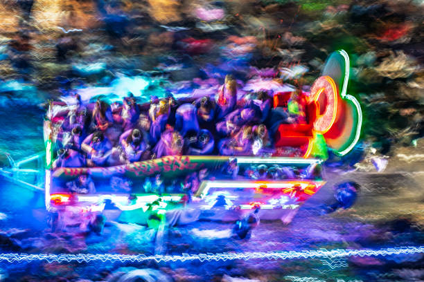 Aerial view of a lively float during a colorful night parade in Seville, Spain.