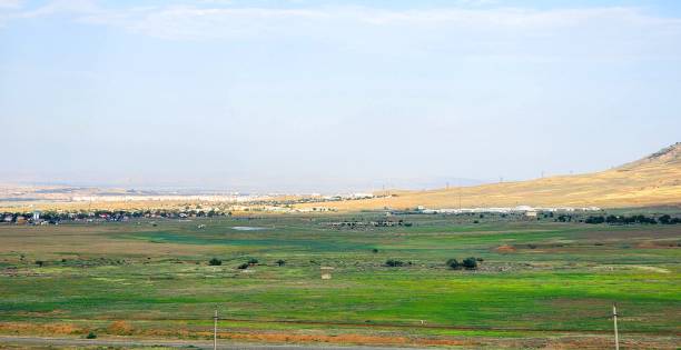 istock Expansive countryside with distant town, Caucasus region, Georgia 2206221971