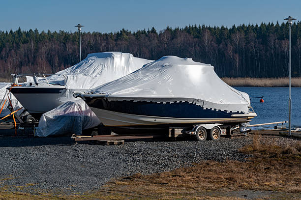 istock Two motor boats with plastic cover for winter storage 2206223480