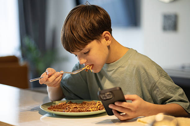 istock Happy Boy Enjoying Spaghetti Meal 2206224337