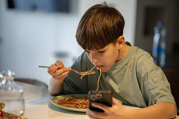 istock Happy Boy Enjoying Spaghetti Meal 2206224360