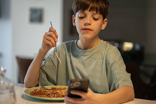 istock Happy Boy Enjoying Spaghetti Meal 2206224365